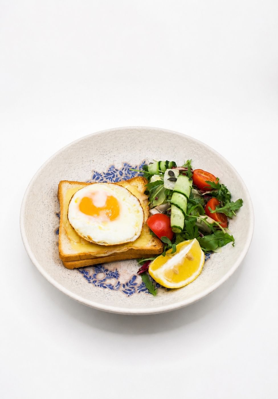 Egg on sourdough toast with salad at Café Momus
