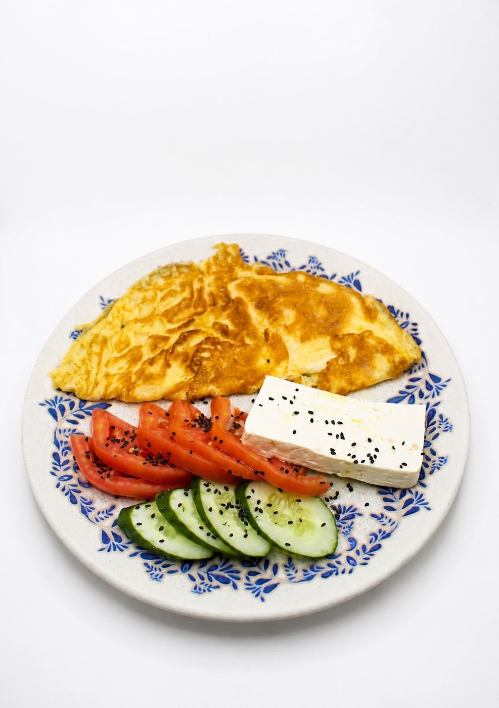 Albanian-style breakfast: omelette with white cheese, tomato and cucumber