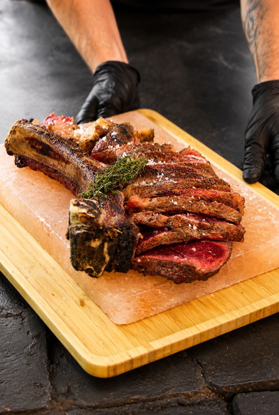 Sliced grilled steak on a wooden board